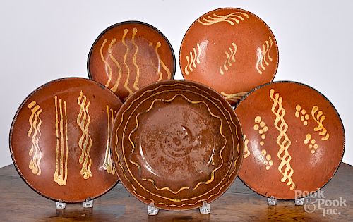 Four PA slip decorated redware plates, etc.