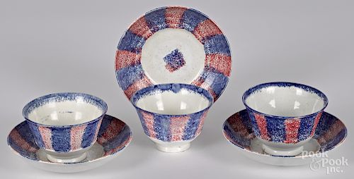 Red and blue rainbow spatter cups and saucers
