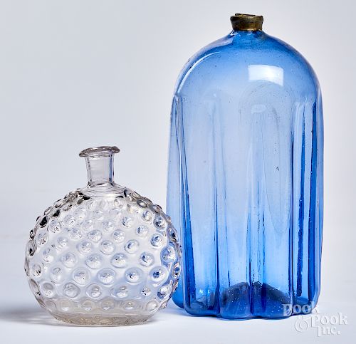 Pale purple blue glass bottle and colorless flask