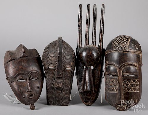 Four carved African masks