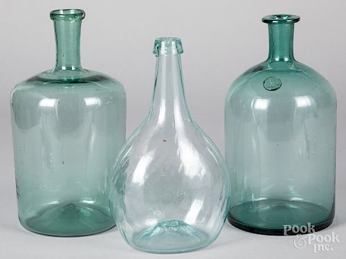 Three blown aquamarine bottles