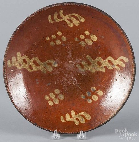 Pennsylvania redware plate, 19th c., with yellow slip decoration, 11 1/4'' dia.