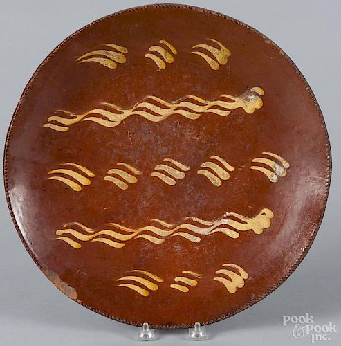Pennsylvania slip decorated redware charger, early 19th c., 14'' dia.