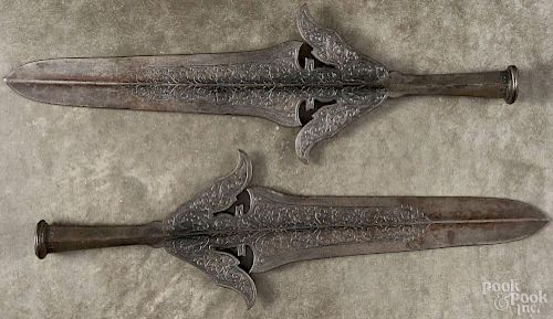 Two cast iron pike points, 20th c., 21'' l.