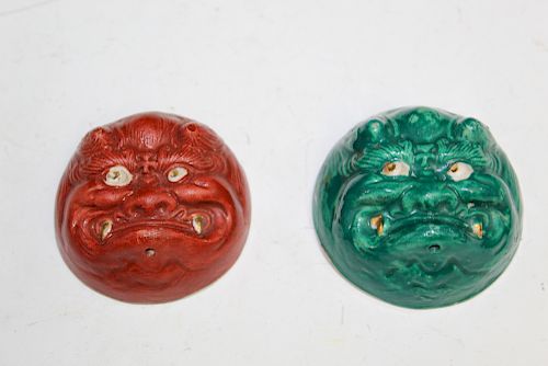 A pair of Japanese mask teacups.