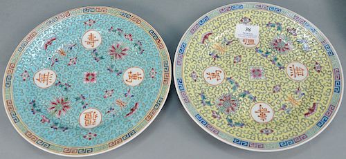 Two sets of Chinese porcelain plates, seventeen Famille Rose (dia. 10 in.) with blue ground, and thirteen with yellow ground (dia.10 in.).