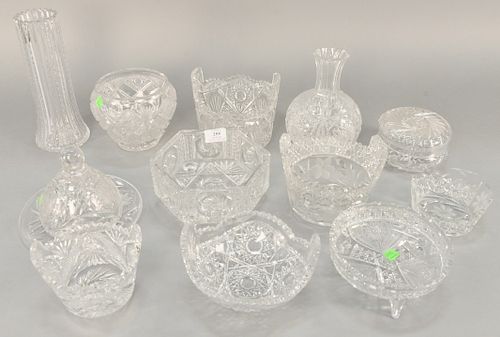 Group of twelve cut glass pieces, to include five baskets, two footed dishes, two covered pieces, and three vases. tallest: 10 1/2 in.
