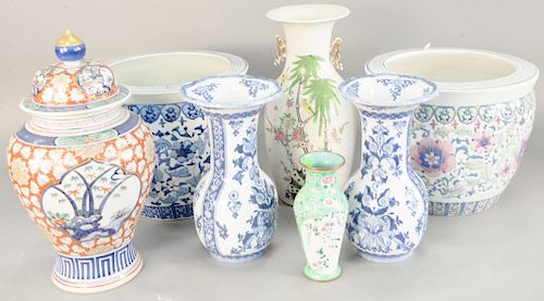 Seven Oriental pieces, Chinese porcelain vase, enameled vase, Japanese urn, pair of blue and white vases, and two chinese planters, heights 9 in., to 