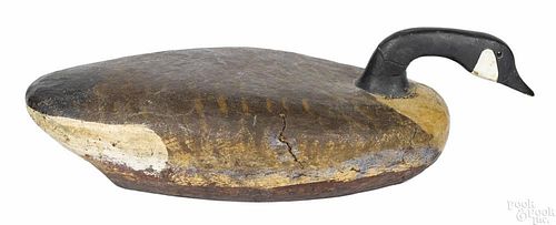 Carved and painted swimming Canada goose decoy, mid 20th c., having a cork over wood body, 27 1/2'' l.