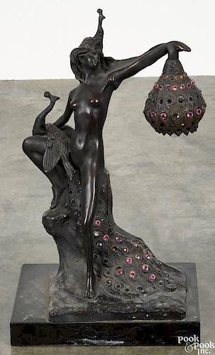 Art nouveau figural bronze table lamp, 20th c., depicting a nude woman and a peacock
