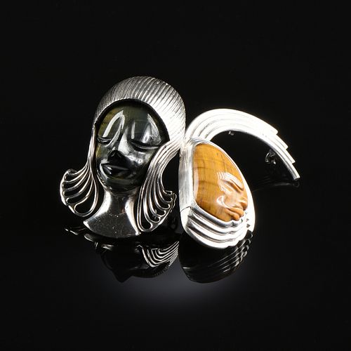 A PAIR OF MEXICAN STERLING SILVER AND TIGER'S EYE MASK BROOCHES, TALLERES DE LOS BALLESTEROS, TAXCO, GUERRERO, MID 20TH CENTURY,