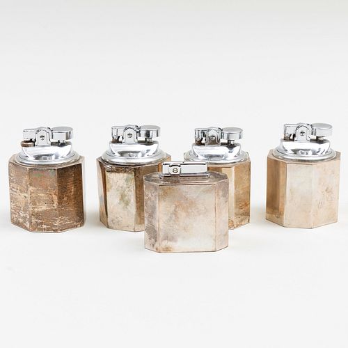 Group of Four Cartier Silver Table Lighters 