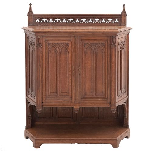 Cabinet. France. 20th Century. Gothic Style. Carved in oak. 2 hinged doors, upper and lower shelves. 56.6 x 46.4 x 16.9"  (144 x 118 x 43 cm).