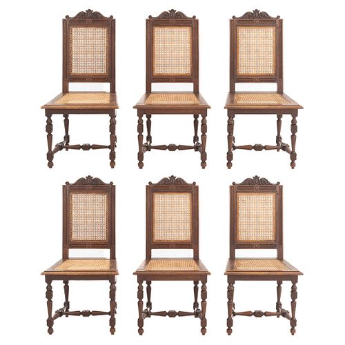 Lot of 6 chairs. France. 20th Century. Henri II. Carved in oak. Backrests and seats in bejuco.