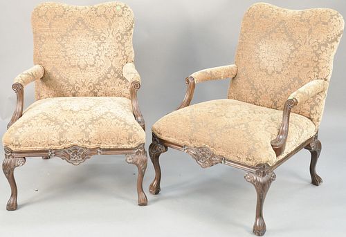 Pair of carved upholstered arm chairs. ht. 38 in., wd. 28 in. Provenance: Former home of Mel Gibson, Old Mill Rd, Greenwich, CT
