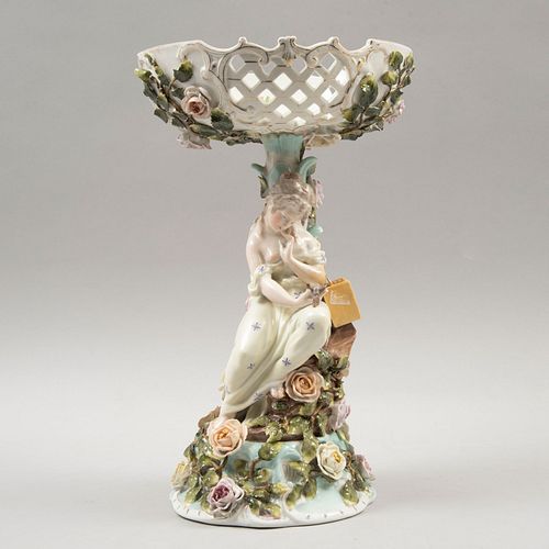 Centro. Alemania, siglo XIX. Elaborado en porcelana tipo SITZENDORF acabado brillante. Con mujer sosteniendo un ave.