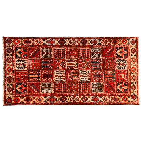 Tapete. Persia, siglo XX. Diseño Casetonado. Anudado a mano con fibras de lana y algodón. 310 x 156 cm.