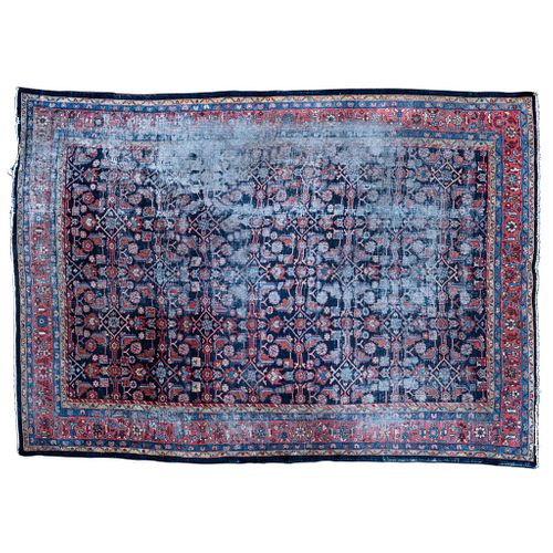 Rug. Iran. Early 20th Century. In wool and cotton. Decorated with floral and geometric motifs. 100.7 x 135.4" (256 x 344 cm).