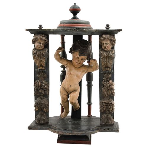 Niche. Mexico. 19th Century. Carved, polychromed wood. Figure of baby Jesus in burnished wood. Decorated with vegetable motif.