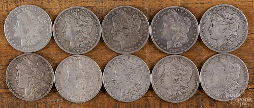 Ten Morgan silver dollars of various dates and conditions, 1878-1902.