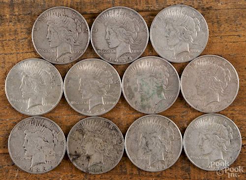 Eleven silver Peace dollars, to include two 1934, two 1934 D, six 1935, and one 1935 S