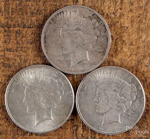 Three silver Peace dollars, to include two 1927 and one 1927 D, XF-AU.