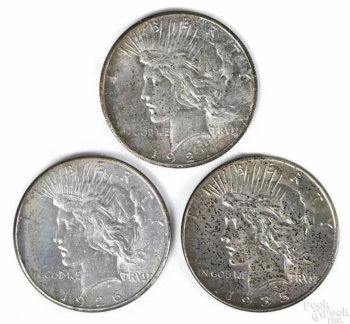 Three silver Peace dollars, to include a 1926 S, UNC, a 1927, UNC, and a 1935, UNC.