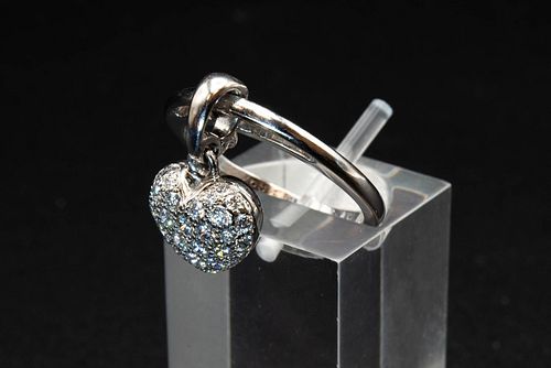 A DIAMOND SET RING BY CARTIER, with an articulated heart charm set with bri