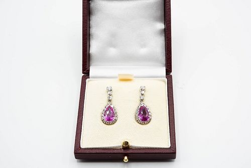 A PAIR OF PINK SAPPHIRE AND DIAMOND EARRINGS, an oval cut pink sapphire wit