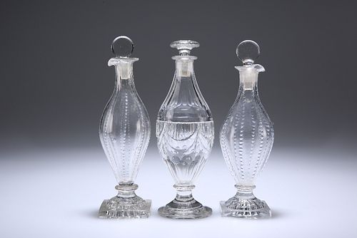 THREE ENGLISH GLASS CONDIMENT BOTTLES AND STOPPERS, CIRCA 1800, comprising 