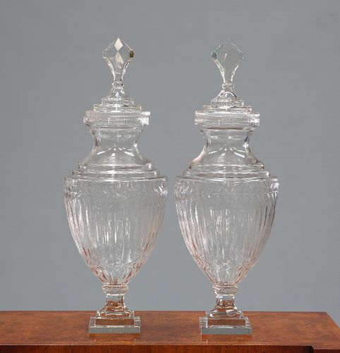 A LARGE PAIR OF ADAM STYLE GLASS URNS AND COVERS, with stepped square base 