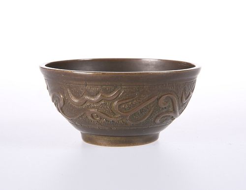 A SMALL ISLAMIC COPPER BOWL, probably 19th Century, decorated in low relief