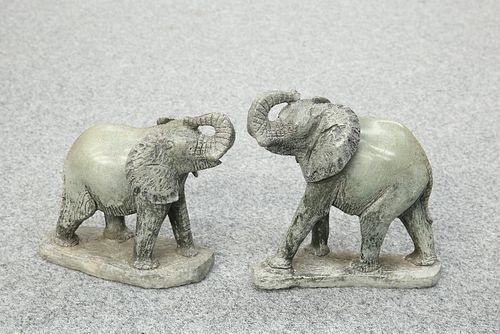 A PAIR OF CARVED STONE MODELS OF ELEPHANTS, each modelled with trunk raised