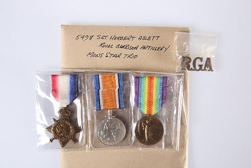 A WORLD WAR I MONS STAR TRIO AND BADGE, 5498 Sgt. Herbert Aslett, Royal Gar