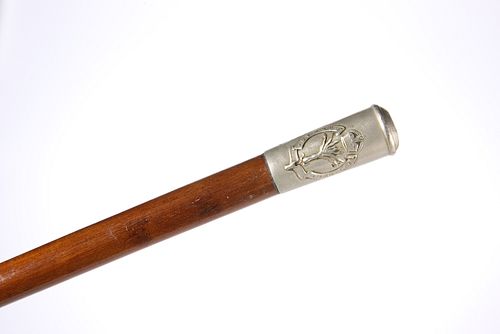 AN EDWARDIAN WELSH REGIMENT SWAGGER STICK, with white-metal top. 76.5cm