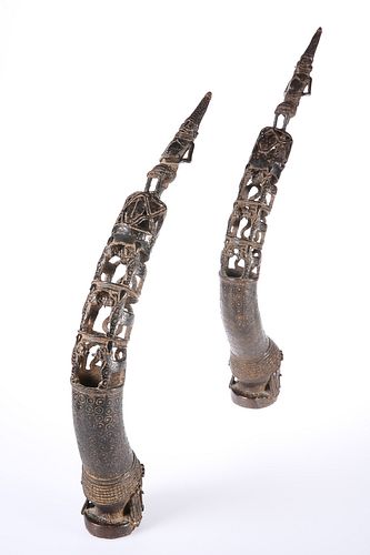 A PAIR OF BENIN BRONZE ROYAL HEAD TRUMPETS, each pierced and cast with figu