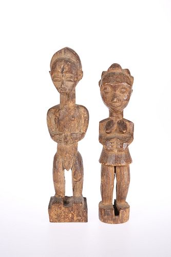 TRIBAL: A PAIR OF CARVED WOODEN FIGURES, each modelled with their hands ove