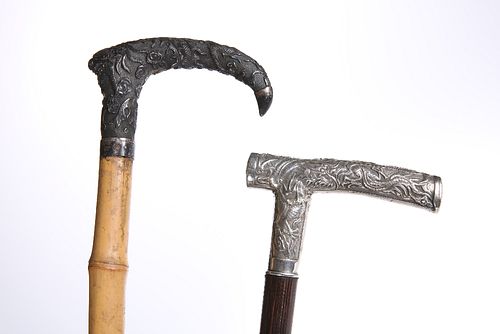 TWO CHINESE WHITE-METAL HANDLED WALKING STICKS, LATE 19TH CENTURY, one with