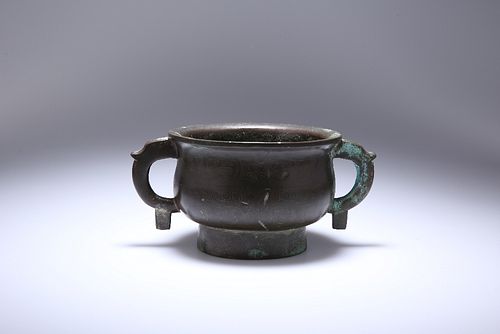 A CHINESE BRONZE CENSER, of baluster form, with twin shaped handles and wit