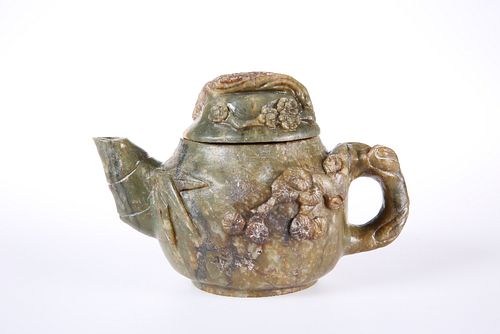 A CHINESE CARVED HARDSTONE TEAPOT, carved in relief with prunus blossom. 11