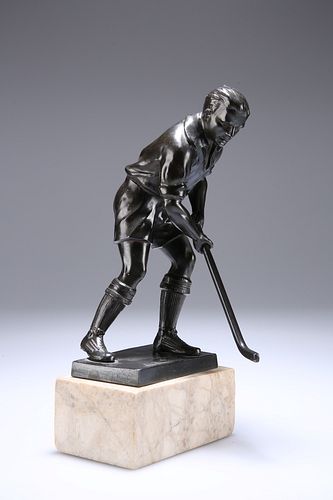 A PATINATED METAL FIGURE OF A HOCKEY PLAYER, on a marble base. 24cm high ov