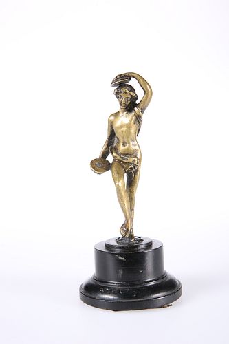 AFTER THE ANTIQUE, A DESK BRONZE OF A FEMALE NUDE WITH CYMBALS, mounted on 