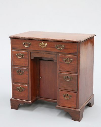 A GEORGE III MAHOGANY KNEEHOLE DESK, the moulded rectangular top with inver