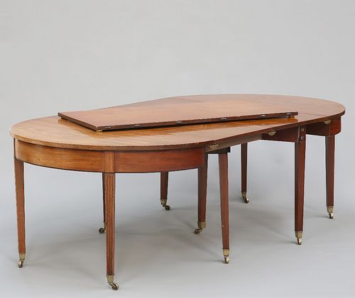 A GEORGE III MAHOGANY D-END DINING TABLE, the D-ends enclosing three leaves