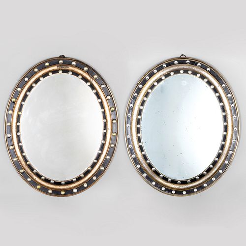 Near Pair of Irish Ebonized, Parcel and Silver-Gilt and Beaded Glass Oval Mirrors