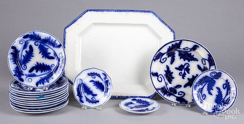 Fourteen flow blue plates, a shallow bowl