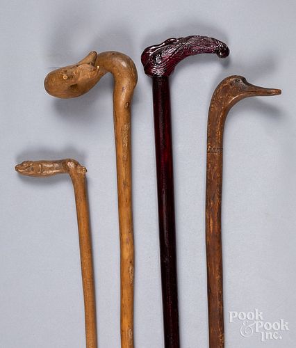 Four carved canes, with animal grips.