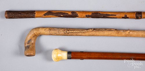 Two carved canes, together with a bone grip cane.