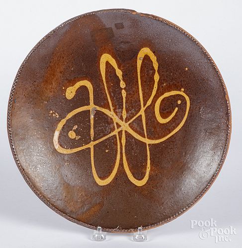 Slip decorated redware charger, 19th c.