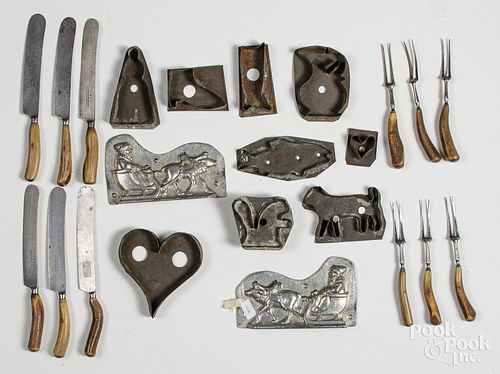 Tin cookie cutters, together with flatware
